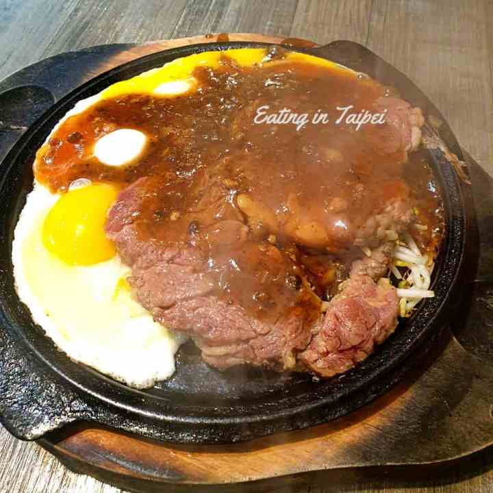 Sizzling steak served on a cast iron skillet